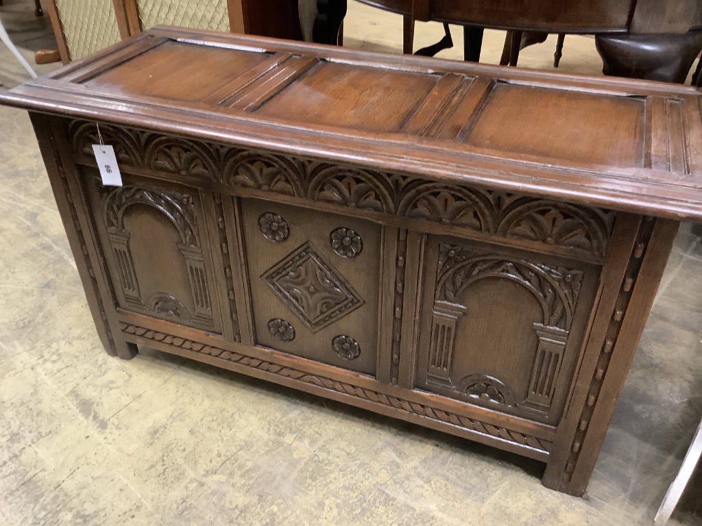An 18th century style carved oak panelled coffer, width 105cm depth 45cm height 58cm